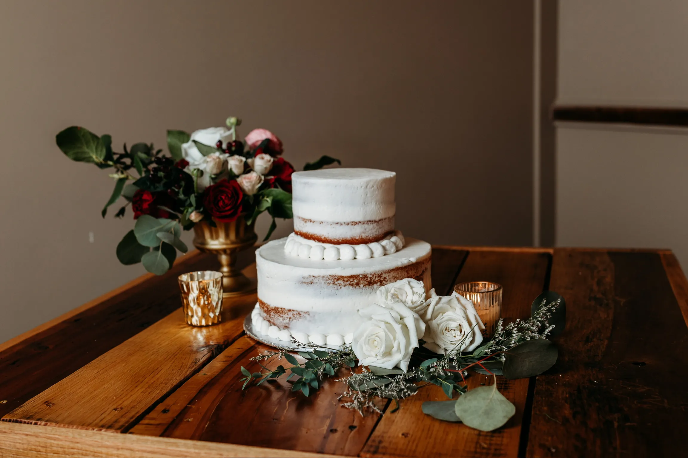Wedding cake table with white rose and greenery florals